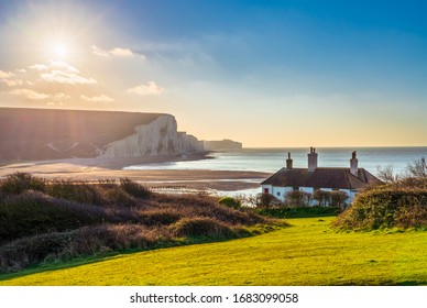 The Coast Guard Cottages & Seven Sisters Chalk Cliffs At Sunrise In Sussex, England, UK