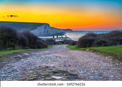 The Coast Guard Cottages And Seven Sisters Chalk Cliffs At Sunrise In Sussex, England, UK