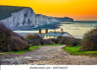 The Coast Guard Cottages & Seven Sisters Chalk Cliffs At Sunrise In Sussex, England, UK