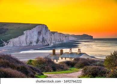 The Coast Guard Cottages And Seven Sisters Chalk Cliffs At Sunrise In Sussex, England, UK