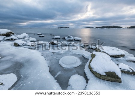 The coast of the Gulf of Finland in winter at sunset
