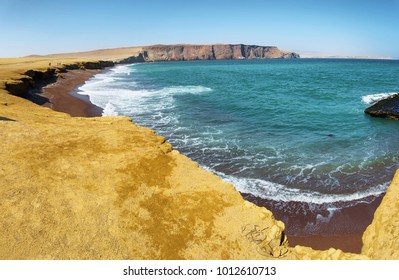 The coast and red sand beach of Paracas National Reserve in Peru