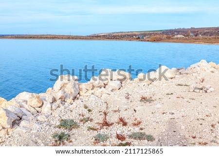 Coast with white stones . Lake shore with rocks