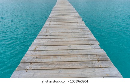 Coast, Wooden pier next to the Mediterranean sea on the island of Ibiza in Spain, holiday and summer scene