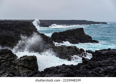 The coastal cliffs near Brimketill rock pool on a stormy day, with huge sea waves crashing against the black basalt rocks, Reykjanes peninsula, Iceland - Powered by Shutterstock