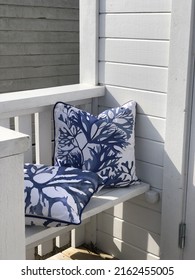 Coastal Cushions On Bench In A White Beach Hut.