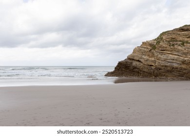 Coastal erosion scenic landscape with rocky cliffs overcast sky serene beach calm waters. Cathedral beach, Lugo, Spain - Powered by Shutterstock