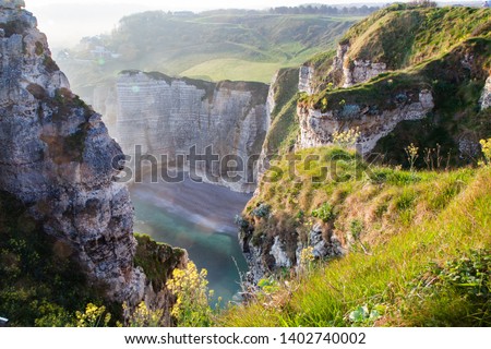coastal landscape along the Falaise d'Aval the famous white cliffs of Etretat village, Normandie France