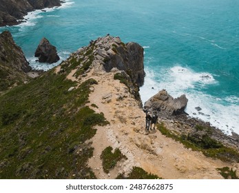 Coastal landscape in Cabo de Roca on a summer day. A couple of tourists on a cliff, photo view from a drone.  - Powered by Shutterstock