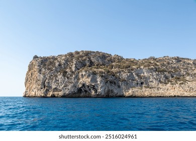 Coastal landscape image of the cliffs along the Spanish coastline from a boat, Image shows a beautiful scenic photo of the cliffs with blue skies and blue sea  - Powered by Shutterstock