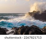 a coastal landscape on la plasma canary island, spain, at sunset, a romantic atmosphere, a very rough sea with high waves, the waves are breaking on the rocks