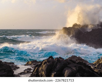 a coastal landscape on la plasma canary island, spain, at sunset, a romantic atmosphere, a very rough sea with high waves, the waves are breaking on the rocks - Powered by Shutterstock