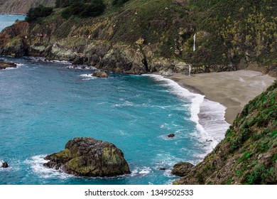 A coastal overlook with a view of dramatic waterfalls along the Pacific Coast Highway in Big Sur, California. - Powered by Shutterstock