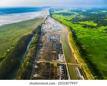 Coastal Salt Flats Aerial View: A breathtaking aerial perspective captures the intricate network of salt flats along a verdant coastline, showcasing the beauty of nature's artistry. - Powered by Shutterstock