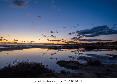 Coastal Sunset Serenity: A tranquil sunset scene with vibrant colors reflected in the calm waters of a tidal pool, creating a peaceful and picturesque coastal landscape - Powered by Shutterstock