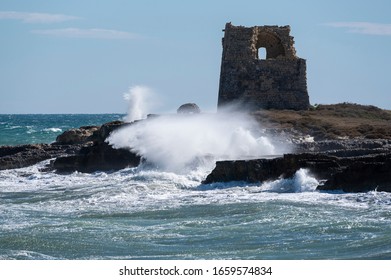 Coastal Tower With Rough Sea And Wave Hitting The Rocks 