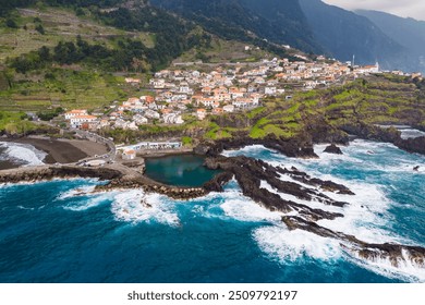 Coastal town Seixal on north Madeira island with stormy waves of Atlantic ocean. Aerial view - Powered by Shutterstock