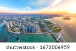 Coastal Urban Scenery of Haikou City with Landmark Buildings, Parks and Bridges at Sunset, the Capital City of Hainan Province, a Pilot Free Trade Zone and Tourism Destination in China. Aerial View.