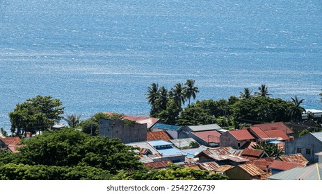 Coastal village with colorful houses and palm trees. - Powered by Shutterstock