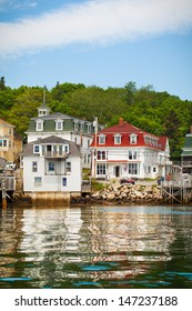 Coastal Village In Maine, Viewed From The Water With Reflections