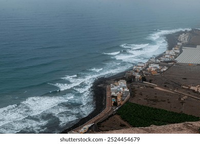 Coastal Village with Rocky Shoreline and Ocean Waves from Elevated View - Powered by Shutterstock