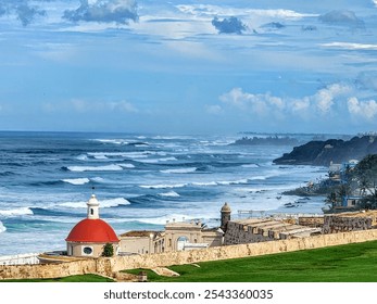 Coastal waves crashing along the shore near a historic fortress with a red dome. - Powered by Shutterstock