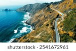 Coastal winding road along rugged cliffs. A dramatic aerial view of a winding coastal road hugging steep cliffs beside a turquoise ocean.