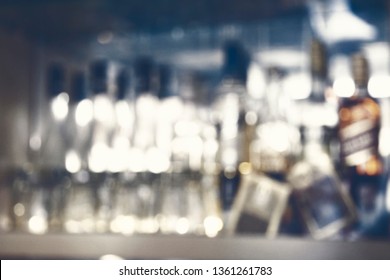 Coaster Under Glass On Blurred Bar Background. Empty The Top Of Wooden Table With Blurred Counter Bar And Bottles Background