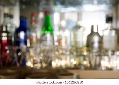 Coaster Under Glass On Blurred Bar Background. Empty The Top Of Wooden Table With Blurred Counter Bar And Bottles Background