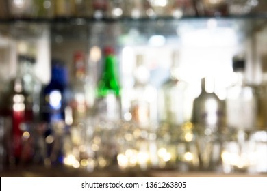 Coaster Under Glass On Blurred Bar Background. Empty The Top Of Wooden Table With Blurred Counter Bar And Bottles Background