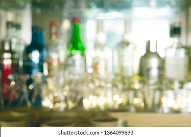 Coaster Under Glass On Blurred Bar Background. Empty The Top Of Wooden Table With Blurred Counter Bar And Bottles Background