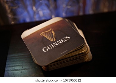 Coasters Of Guinness Beer In Bar In Brussels, Belgium On April 24, 2018