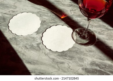 Coasters thin white scallop shape with wine glass under sunlight - Shutterstock ID 2147102845