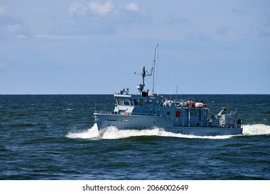 Coastguard, rescue and support patrol boat for defense sailing in blue sea. Navy patrol vessel protecting water borders and fisheries. Military ship, warship, battleship. Baltic Fleet, Russian Navy