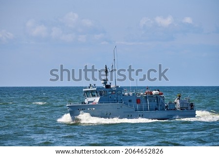 Coastguard, rescue and support patrol boat for defense sailing in blue sea. Navy patrol vessel protecting water borders and fisheries. Military ship, warship, battleship. Baltic Fleet, Russian Navy