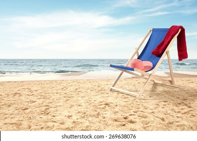 coastline and red towel blue chair and hat  - Powered by Shutterstock