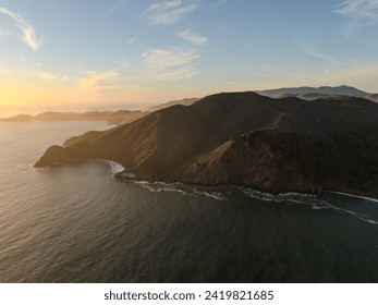 Coastline with rolling hills and fog during sunset - Powered by Shutterstock