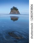 Coastline with sea stacks  in sunset time with red and purple light. Rialto Beach in Olympic National Park, Olympic Peninsula near Seattle, Olympia, Port Angeles. Washington. United States of America