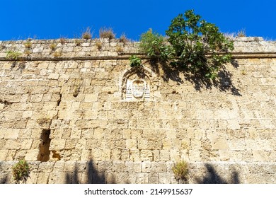 Coat Of Arms Of The Order Of Knights Of The Hospital Or Hospitallers On The Wall Of The Citadel Of Medieval City Rhodes. Principal City On The Island Of Rhodes In The Dodecanese, Greece. 