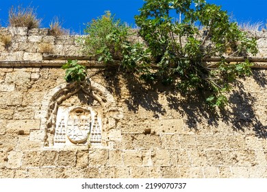 Coat Of Arms Of The Order Of Knights Of The Hospital Or Hospitallers On The Wall Of The Citadel Of Medieval City Rhodes. Principal City On The Island Of Rhodes In The Dodecanese, Greece.