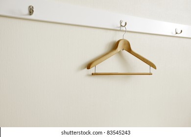 Coat Hanger On White Wall.