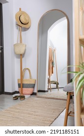 Coat Rack With Accessories And Floor Mirror In Hallway