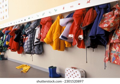 Coat rack in a nursery with a lot of chidren coats