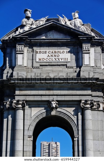 Coats of arms of the frieze on the left and right\
side and Lion\'s head on the west side of Puerta de Alcala (Alcala\
Gate or Citadel Gate), Figureheads on the keys in the door\
(arches), Madrid, Spain