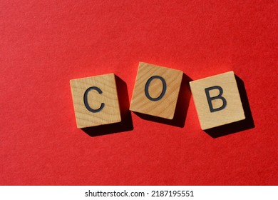 COB, abbreviation for Close of Business in wooden alphabet letters isolated on red background - Shutterstock ID 2187195551