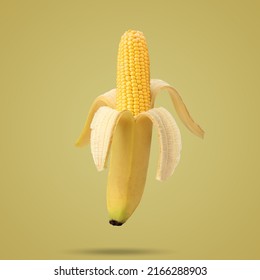 Cob Of Corn In The Peel Of Banana On Yellow Background. Fruit Concept. Food Creative Concept. Photo Manipulation With Banana. Art Concept.