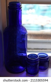 Cobalt Blue Glass Bottles On A Windowsill