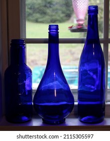 Cobalt Blue Glass Bottles On A Windowsill