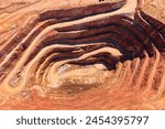 Cobar copper mine open pit excavated deep whole in the ground of NSW, Australia - aerial top down.