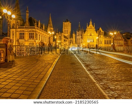 Cobble Stones road on top of Sint-Michielsbrug Arched stone bridge at night in Ghent, Belgium